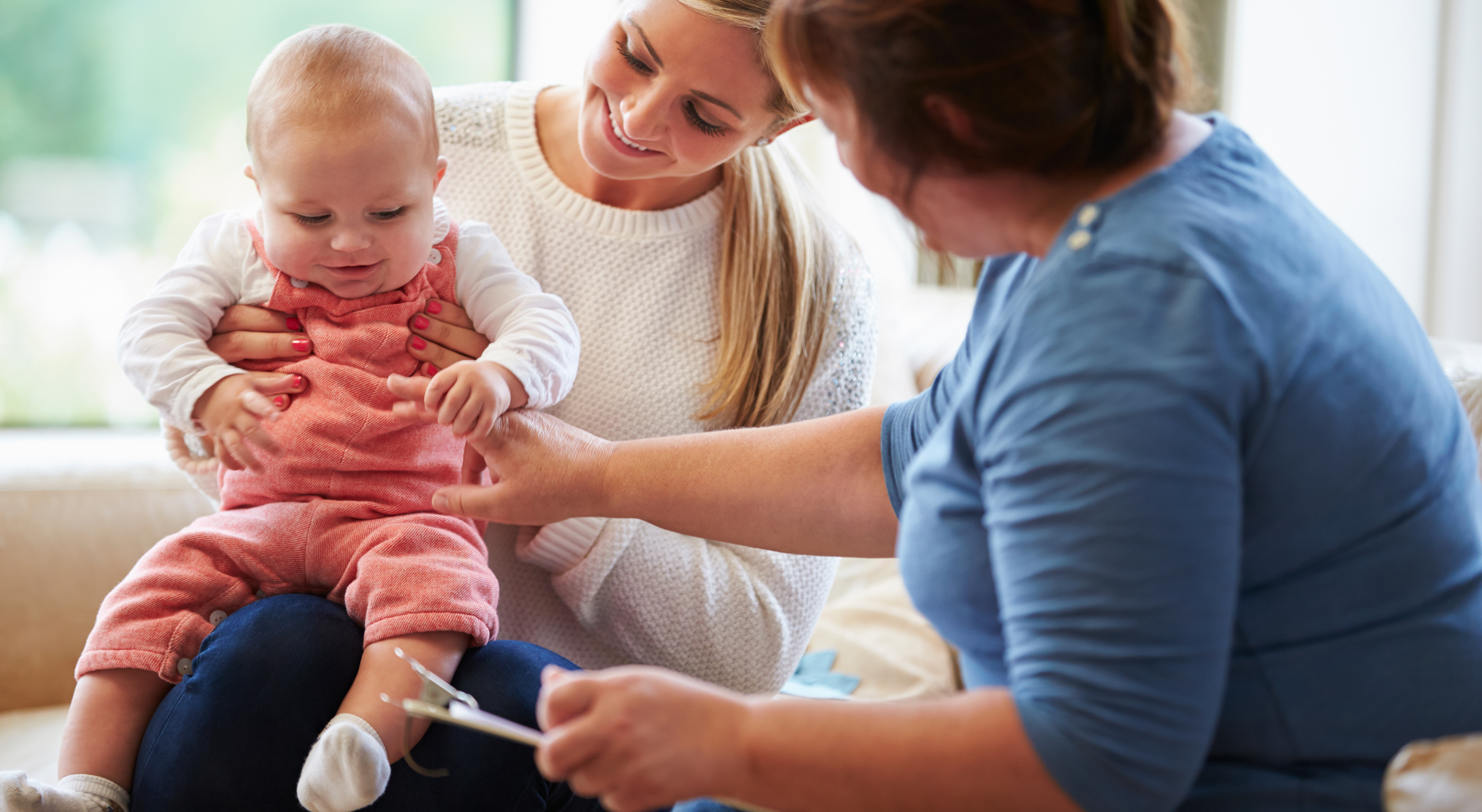 Home Visitor Talking To Mother With Young Baby