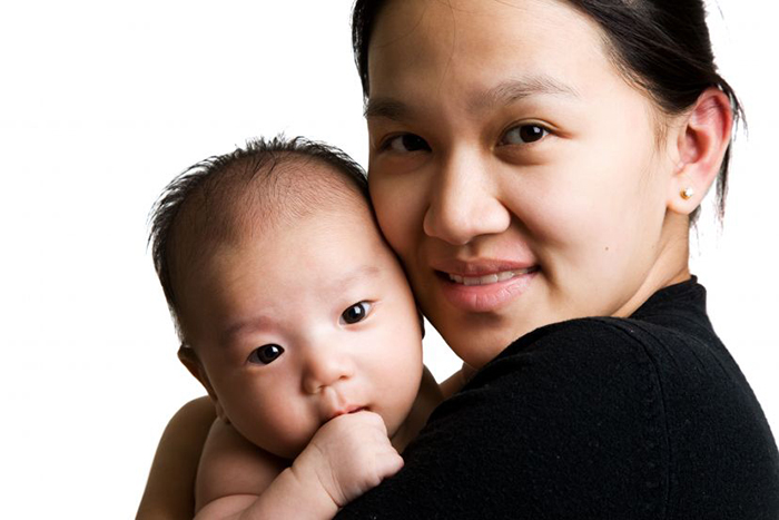 Asian mother holding her baby